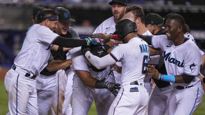 Marlins' Garrett Cooper reacts to his game-winning grand slam to sweep  Tigers 