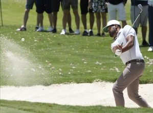 Jon Rahm shoots course record as title defence hots up