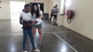 Professional Wallball player Stephanie Vega explaining the game to a young man at the demonstration.