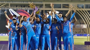 The Mumbai Indians hoist the WPL trophy after defeating the Delhi Capitals by seven wickets in the final on Sunday.