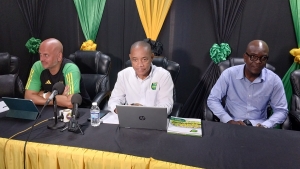 JFF&#039;s General Secretary Dennis Chung (centre) is flanked by General manager Roy Simpson (right) and Reggae Boyz assistant coach John Wall during a press conference at JFF&#039;s  offices on Wednesday.
