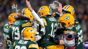 Packers clinch NFC top seeding as Rodgers and Adams star