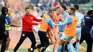 Pitch invasion causes Melbourne derby abandonment as goalkeeper Glover struck by a bin