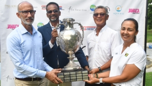 Some of the main stakeholders (from L –R) Allan Beckford-general manager at SDF, Dr. Carey Wallace - executive director of TEF, Peter Chin – chairman of the Jamaica Open organizing committee and Jodi Munn-Barrow – president of the JGA happily hang on to the event trophy at the launch of the 45th staging of the open. The launch was on Thursday October 31 at the Constant Spring Golf Club in Kingston.  