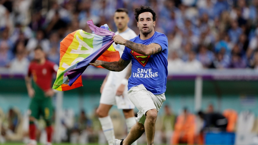 Pitch invader with rainbow flag halts play in Portugal-Uruguay game