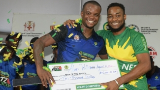 Team Boscobel’s Alwyn Williams (left), the Man of the Match for the SDC/Wray &amp; Nephew Cricket Finals on Sunday, August 21, 2022, receives the J$10,000 prize from Pavel Smith (right), Marketing Manager at J. Wray &amp; Nephew Limited.