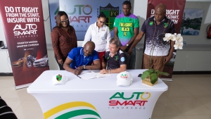 (Front row left) General Accident (GenAc) Chief Operating Officer Gregory Foster is pleased to seal the AutoSmart sponsorship deal with Treasure Beach Football Club (TBFC) Chairman Jason Henzel following a signing ceremony at the AutoSmart offices on October 11, 2023.  Looking over the $3 million sponsorship contract is (from left back row) Autosmart General Manager, Janille Jarrett, GenAc Chief Information Officer Lesley Miller, TBFC Team Captain Romario Thompson and Club President Paul Bernard.  