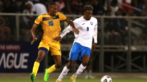 Cuba goal scorer Maykel Reyes is challenged by Barbados&#039; Omani Leacock.