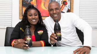 Keteisha McHugh Brand Manager of BOOM Energy Drink with PFJL Chairman Chris Williams at the announcement of the BOOM El Classico set for October.