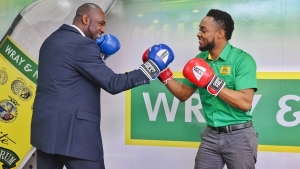 Jamaica Boxing Board Co-Director David Clarke (left) thinks he is a worthy contender of J. Wray &amp; Nephew Ltd Marketing Manager Pavel Smith and engages him in a playful bout after a successful deal signing.