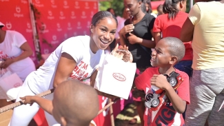 Briana Williams gifting a child from Paradise during her annual treat in Montego Bay on Tuesday.