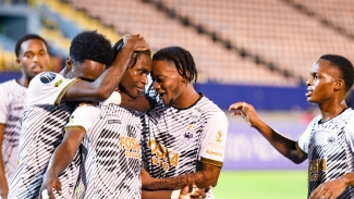 Cavalier players celebrate one of their many goals against Moca FC at the National Stadium.