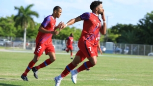 Elijah Seymour of Cayman Islands celebrates the all-important strike.