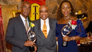 JOA President Christopher Samuda flanked by the honourees Veronica Campbell-Brown at Donald Quarrie in New York on Saturday night. Mr Samuda was guest speaker at the gala hosted by Comets Club International.