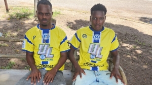 Damek Rennie (r) and his manager Jevaughn Hutchinson. The 17-year midfielder is set to join Club Deportivo Universitario in Panama later this month.