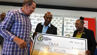 (from left) Lloyd &quot;Bunny&quot; Pommells, SDF&#039;s chairnan of allocation; JAAA&#039;s president Garth Gayle and Olivia Grange, minister of sports, admire the symbolic cheque during the launch of the JAAA&#039;s National Junior and Senior Championships at Jamaica Pegasus on Thursday.