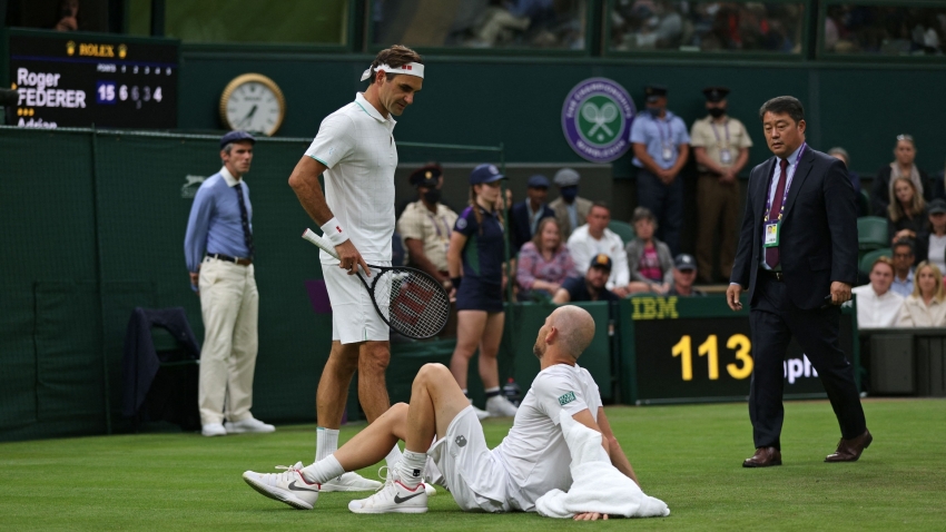 Wimbledon: Federer fortunate as Mannarino injury sends Swiss through