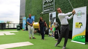 Jonathan Newnham, Director of Golf Operations at Sandals Upton Estate Golf and Country Club, takes the first swing to kick off the Sandals Golf and Jerk Festival 2023 Team Challenge media launch. Zandre Roye, former Care for Kids Junior Golfer (left) and Jamaica Golf Association Representative (right), observes.   