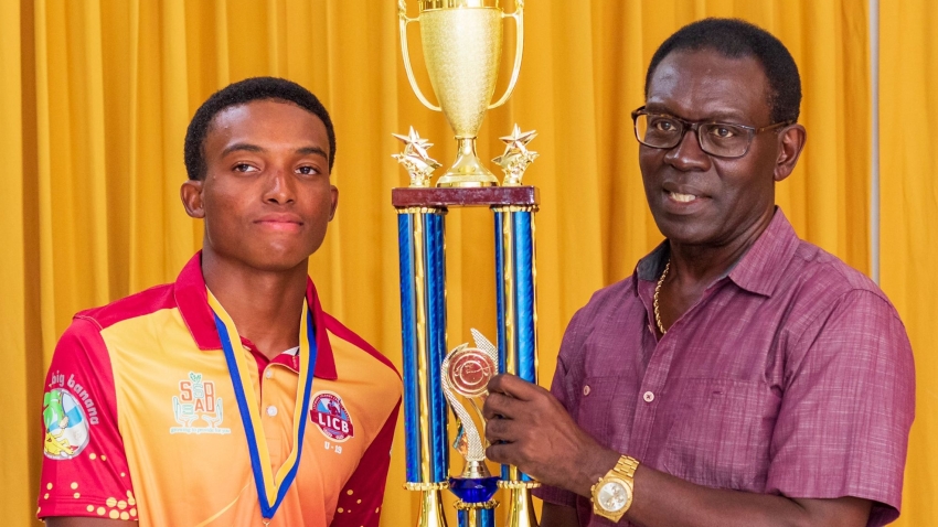 Carlon Bowen-Tuckett receives the U19 trophy from Enoch Lewis, LICA President and CWI Director