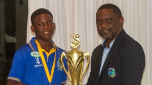 Akobi Crichlow-Byer receives the U15 trophy from Dwain Gill, GCA President and CWI Director