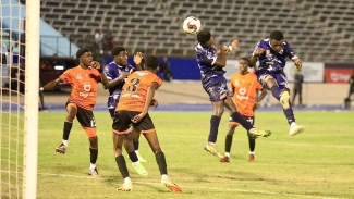 Jamaica College&#039;s Javaun Mills finishes a clinical header during their opening ISSA/Digicel Manning Cup contest against Tivoli High at the National Stadium on Saturday. 