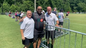 Gerry Mouttet (l) and Gary Peart Chairman Supreme Ventures Limited pose with head coach of the Reggae Rovers Marcelo Castillo (r) in Cary North Carolina at the TST Soccer Tournament on Saturday.