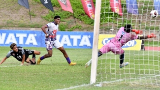 Mona&#039;s goalkeeper Riquelme Edwards parries an effort from Kingston College&#039;s Matrim Martin.