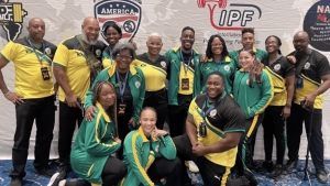 Jamaica Spartans Technical Director Jeremy Owen (second left) and NPAJ President Michael Blair (left) share a photo opportunity with athletes after their successful outing in Arizona recently.