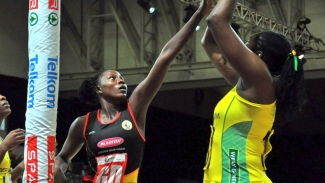 Jhaniele Fowler (right) attempting a shot while Uganda&#039;s  Christine Nakitto defends.