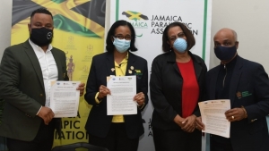 Members of the lead team of the Jamaica Olympic Association (JOA) and Jamaica Paralympic Association (JPA) display the Protocol of Cooperation with the United States Sports Academy (USSA), following the virtual signing ceremony at the JOA headquarters in Kingston. They are (from left)  Ryan Foster, Secretary General/CEO, JOA and Director, JPA, Suzanne Harris-Henry, Secretary General, JPA, Christopher Samuda (second right), President, Jamaica Olympic Association (JOA) and Jamaica Paralympic Association (JPA) and Carmen Patterson, Vice President, JPA.       