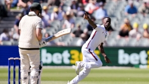 Shamar Joseph celebrates the wicket of Steve Smith with his first ball in Test cricket.