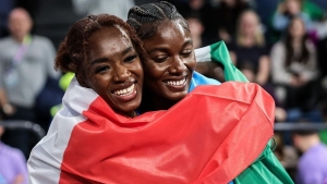 Alfred (r) celebrates her historic victory with Italy&#039;s Zaynab Dosso, who won bronze.