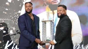 Olympic 100m silver medalist Kishane Thompson receiving his award from JOA Secretary General Ryan Foster at the Terra Nova Hotel in Kingston on Saturday night.