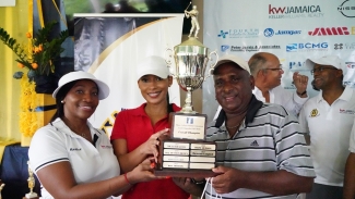 Kameika Swaby and Kalefia Bryan, realtors at Keller Williams present Clifton Johnson with the winning trophy at the MCOBA/Lindy Delapenha Golf Tournament after he tallied 44 points to take the title.