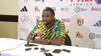 World 100m champion sporting his full Reggae Boyz kit at the Racers Grand Prix press conference at the Jamaica Pegasus on Friday.