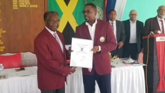 US Ambassador to Jamaica Nikolas Perry receiving a citation from former Cricket West Indies president Dave Cameron during an induction ceremony at the Melbourne Cricket Club on Friday. In the background are Kingston Mayor Delroy Williams, Melbourne Cricket Club President Mark Neita and Executive Director of Cricket Hall of Fame  Mike Chambers.