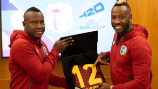 Andre Russell (right) receiving his official T20 World Cup kit from team captain Rovman Powell.