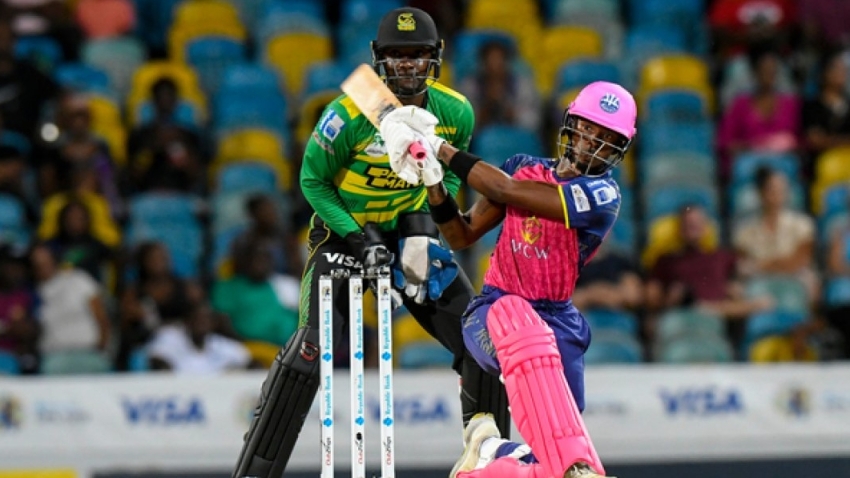 Barbados Royals batsman Alick Athanaze plays a shot as Jamaica Tallawahs wicketkeeper Shamarh Brooks looks on during their CPL contest at Kensington Oval on Thursday.