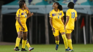 Barbados players celebrate a goal.