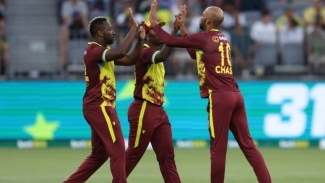 Andre Russell (left), Roston Chase (right) and Sherfane Rutherford celebrate a wicket.