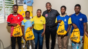 From left: Arnett Gardens’ Daniel Walker, Waterhouse’s Demario Francis, Brand Manager of Malta, Jodi-Ann Campbell, Chief Executive Officer of the Professional Football Jamaica Ltd, Owen Hill, Harbour View’s, Kevin Hall, and Portmore United’s Jeaquan Campbell pose for a photo at the launch of the Elite Under-17 Development Football Programme. at the UWI-JFF Captain Horace Burrell Centre of Excellence yesterday.