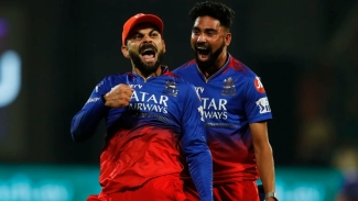 Virat Kohli (left) and Mohammed Siraj celebrating the wicket of Daryl Mitchell.
