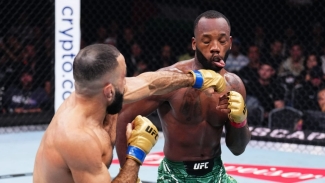 Belal Muhammad lands a jab on Leon Edwards during their UFC 304 main event in Manchester on Saturday.