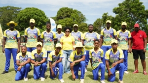  Wray &amp; Nephew White Overproof Rum Brand Manager, Kerry Ann Bryan seamlessly blended into the Whitehouse team photo ahead of their SDC Cricket quarterfinal match played at Chedwin Park in St Catherine on August 10. 