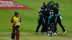 Afy Fletcher walks off as New Zealand players celebrate their win over the West Indies in the second semi-final at the ICC Women&#039;s T20 World Cup in Sharjah on Friday.