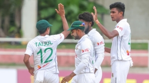 Nahid Rana (right) celebrating a wicket with his teammates.