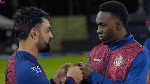 Former West Indies captain and Afghanistan bowling consultant Dwayne Bravo (right) greets Afghanistan captain Rashid Khan.