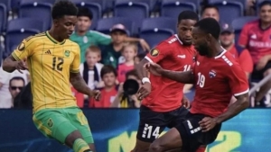 Reggae Boy Demarai Gray (left) and Malcolm Shaw of Trinidad and Tobago challenge for possession during their second Concacaf Gold Cup Group A contest at Citypark in St Louis, Missouri on Wednesday.