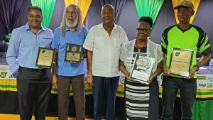 From left: Christopher Maxwell representing his father Geoffrey Maxwell, Allan “Skill” Cole, JFF President Michael Ricketts, Mrs. Florence Marshall representing her husband Leander Marshall and former Reggae Boy Michael Tulloch representing Everton “Bob West” McLeary.