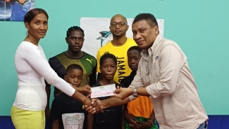 From left: JTTTA President Ingrid Graham, Coach Orvill Young, Coach Dale Parham, Peter Moo-Young and brothers Shacoil Bird, Malone Bird and Anthony Bird.